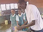 Paul Tergat cutting a slice for the kids - Source: WFP