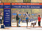 World record-holder Paul Tergat taking the tape ahead of a stumbling Hendrick Ramaala to become the ING New York City Marathon 2005 men's champion - Source: www.nycmarathon.org 